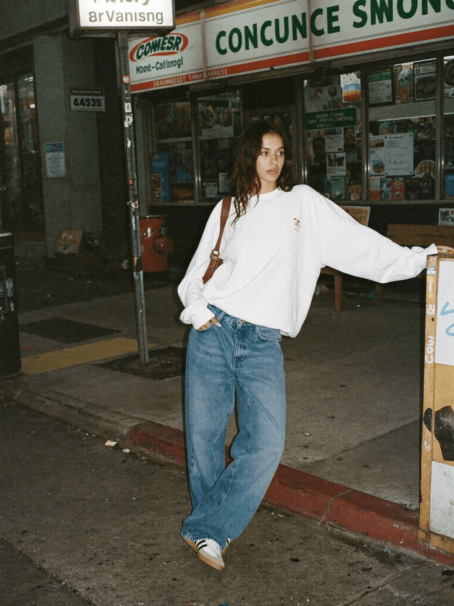 Street style LA, oversized white sweatshirt, wide leg jeans, convenience store backdrop, film grain aesthetic